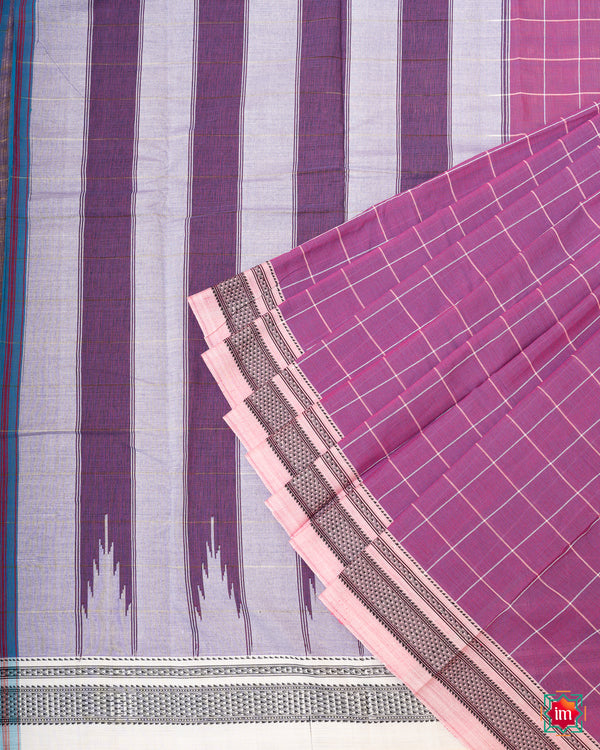 Beautiful orchid purple handloom cotton saree kept on a displayed on a ground.