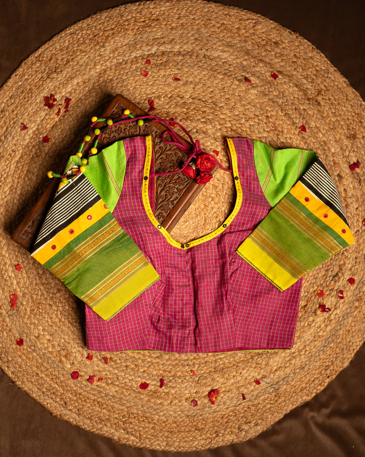 Front side pink blouse best suitable for silk saree kept on the jute round mat.