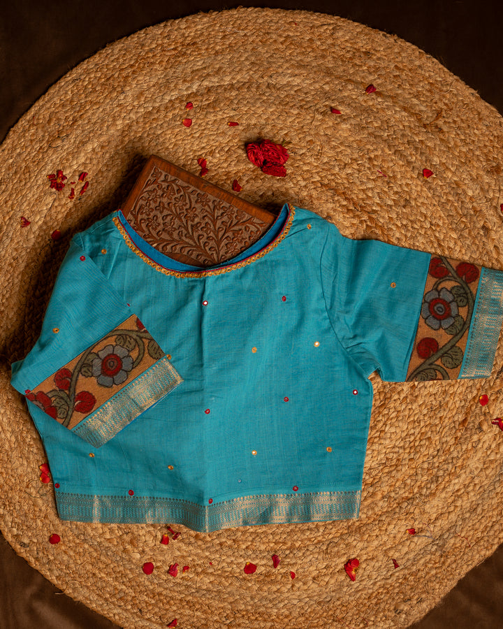 Front side blue blouse best suitable for silk saree kept on the jute round mat.