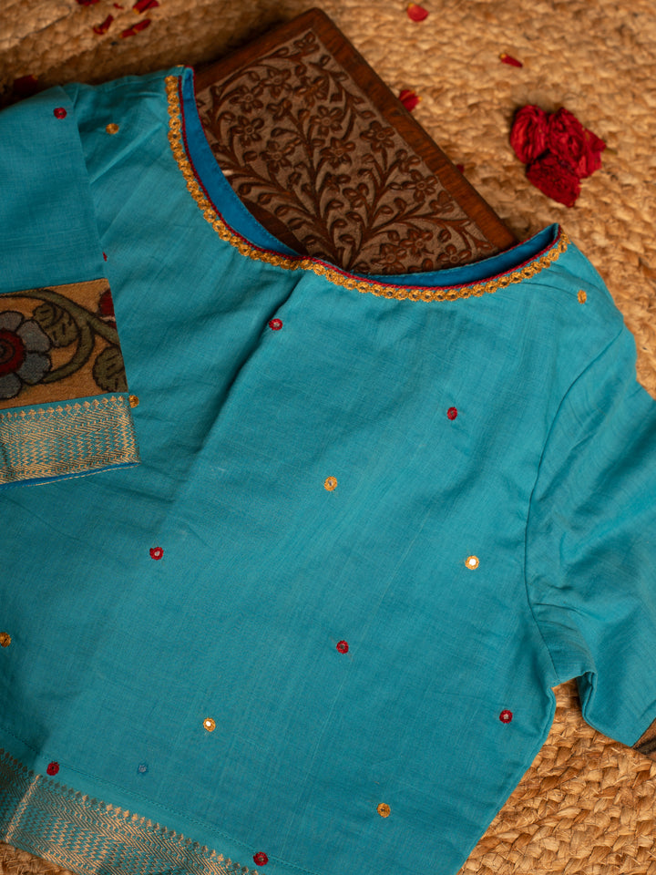 Front side blue blouse best suitable for silk saree kept on the jute round mat.