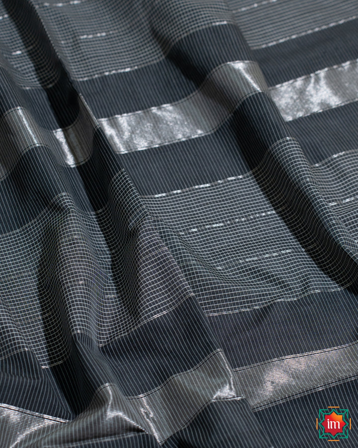 Beautiful grey black silk saree, where in the detailed saree print is displayed.