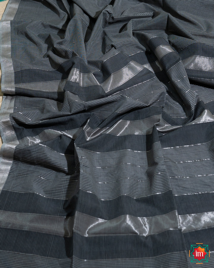 Beautiful grey black silk saree, where in the detailed saree print is displayed.