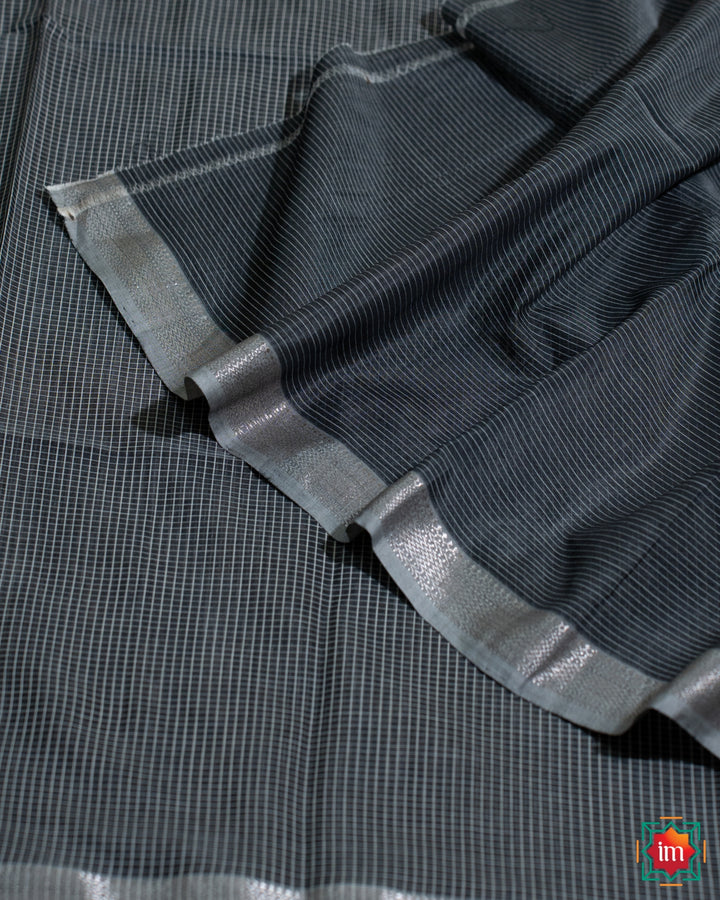 Beautiful grey black silk saree, where in the detailed saree print is displayed.