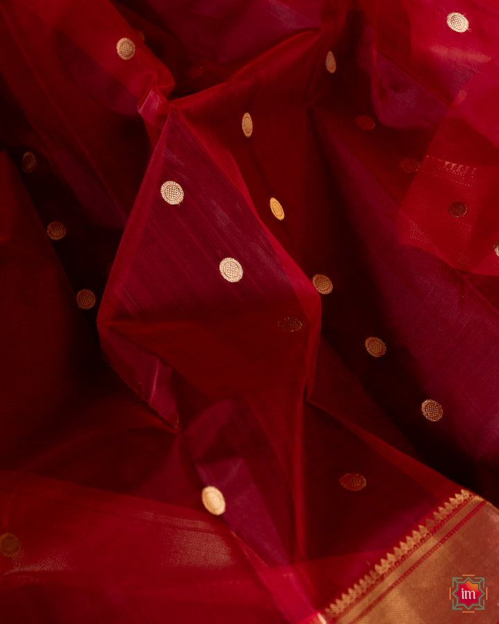 Beautiful red silk saree, where in the detailed saree print is displayed.