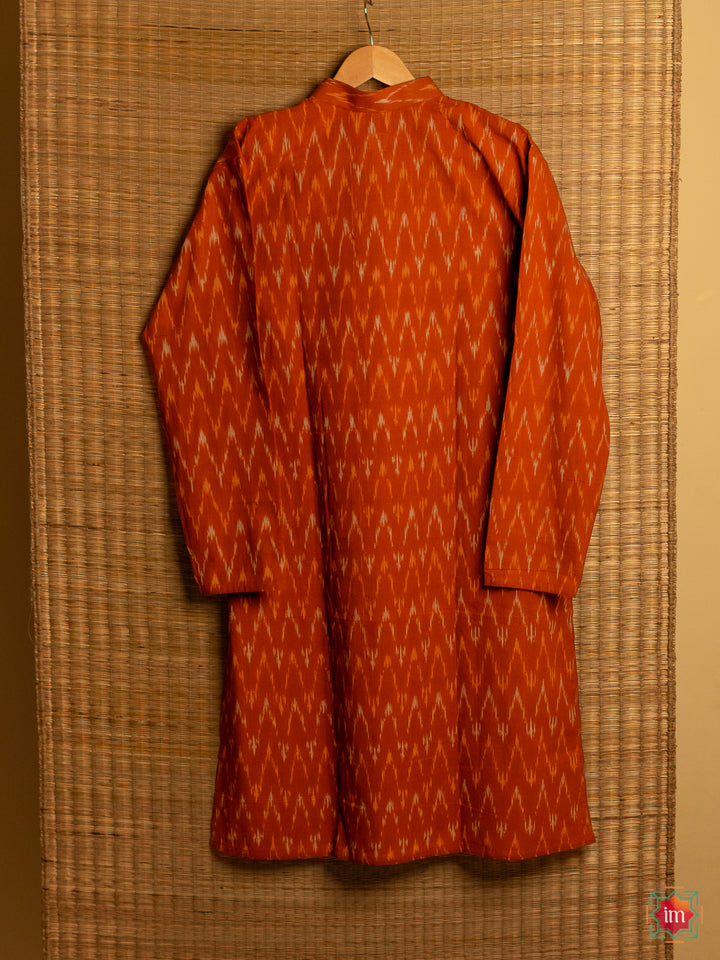 Mens orange kids hanged on a hanger with mat in the background.