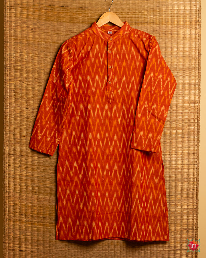 Mens orange kids hanged on a hanger with mat in the background.