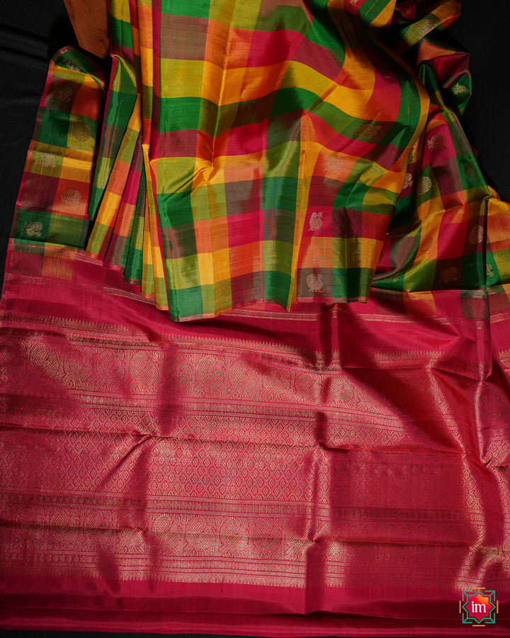 Beautiful multicolour kanjivaram silk saree is pleated and displayed on the floor.