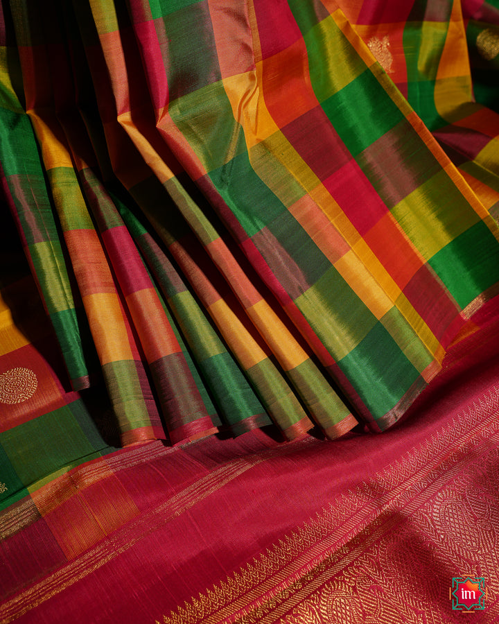 Beautiful multicolour kanjivaram silk saree is pleated and displayed on the floor.