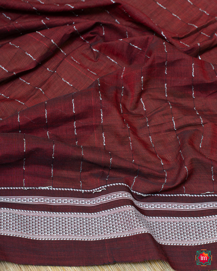Elegant honey red handloom cotton saree, where in the detailed saree print is displayed.