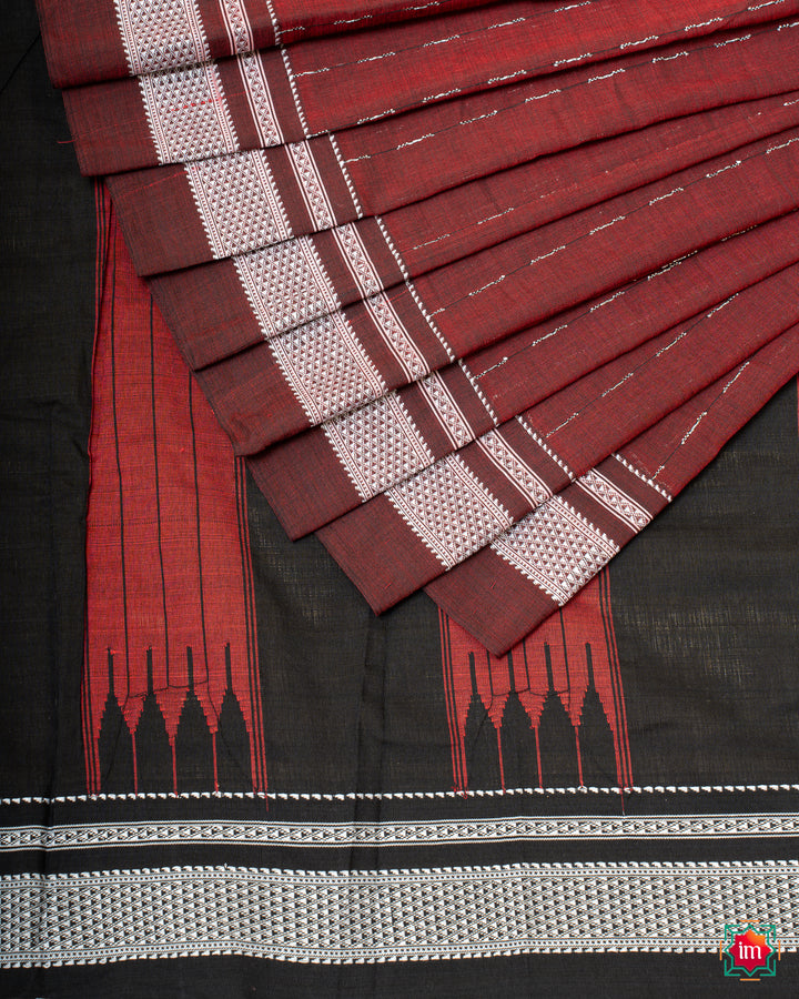 Elegant honey red handloom cotton saree is pleated and displayed on the floor.