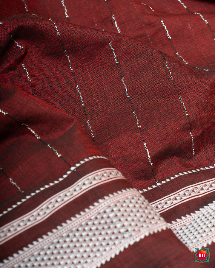 Elegant honey red handloom cotton saree, where in the detailed saree print is displayed.