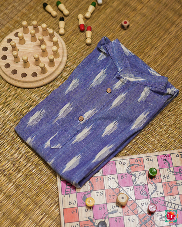 Beautiful light purple girl kurta which is kept on a mat background with some children indoor games which are kept beside.
