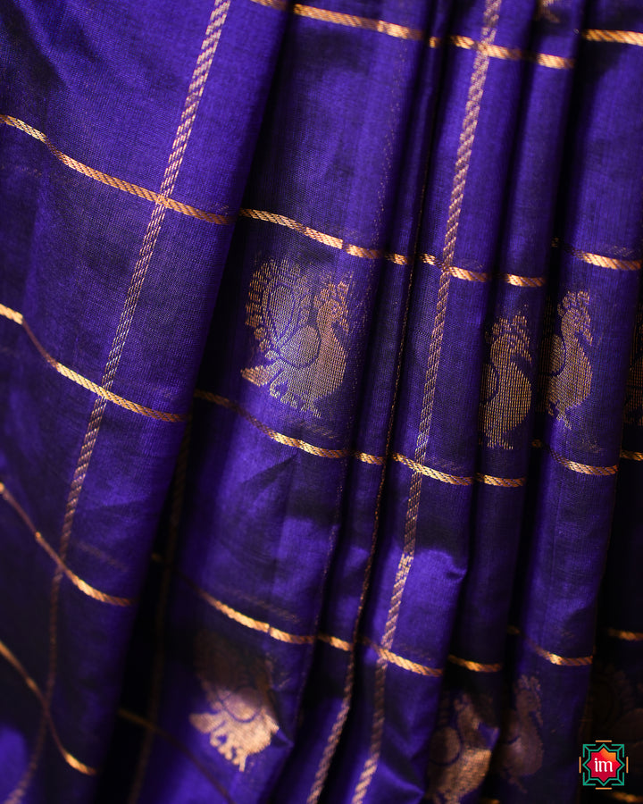 Elegant Cobalt Blue silk Saree is pleated and displayed on the floor.