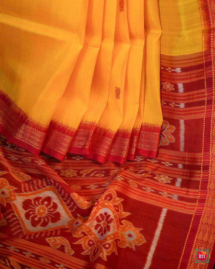 Elegant Yellow Red Khandua Silk Saree Kalyani Bilahari is pleated and displayed on the floor.