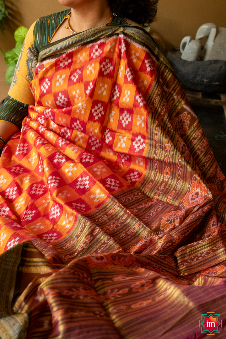 Red yellow silk saree, where in the detailed saree print is displayed.