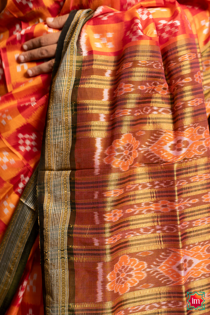 Red yellow silk saree, where in the detailed saree print is displayed.