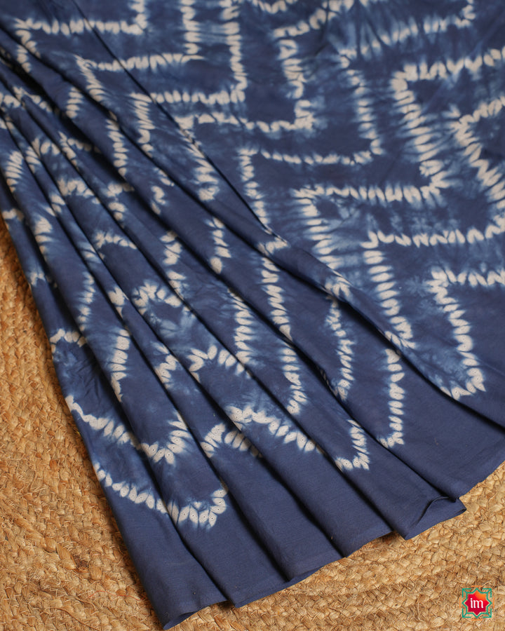 Beautiful blue handloom saree is pleated and displayed on the floor.