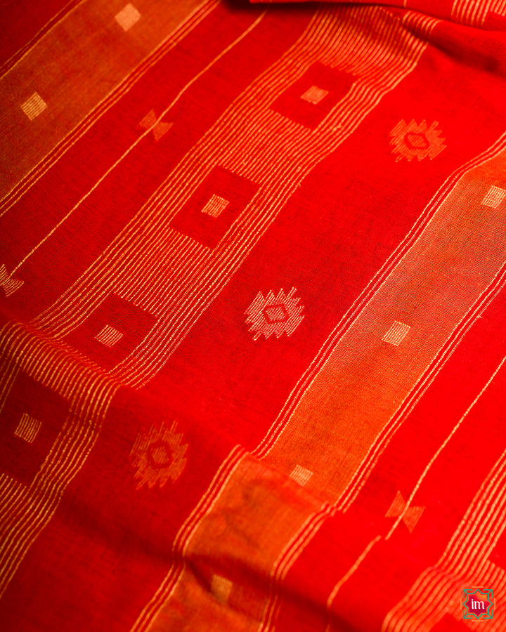 Cherry red handloom saree, where in the detailed saree print is displayed.